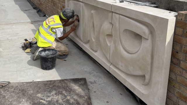 Stonemason from LCC Restorations installs the new replica panel